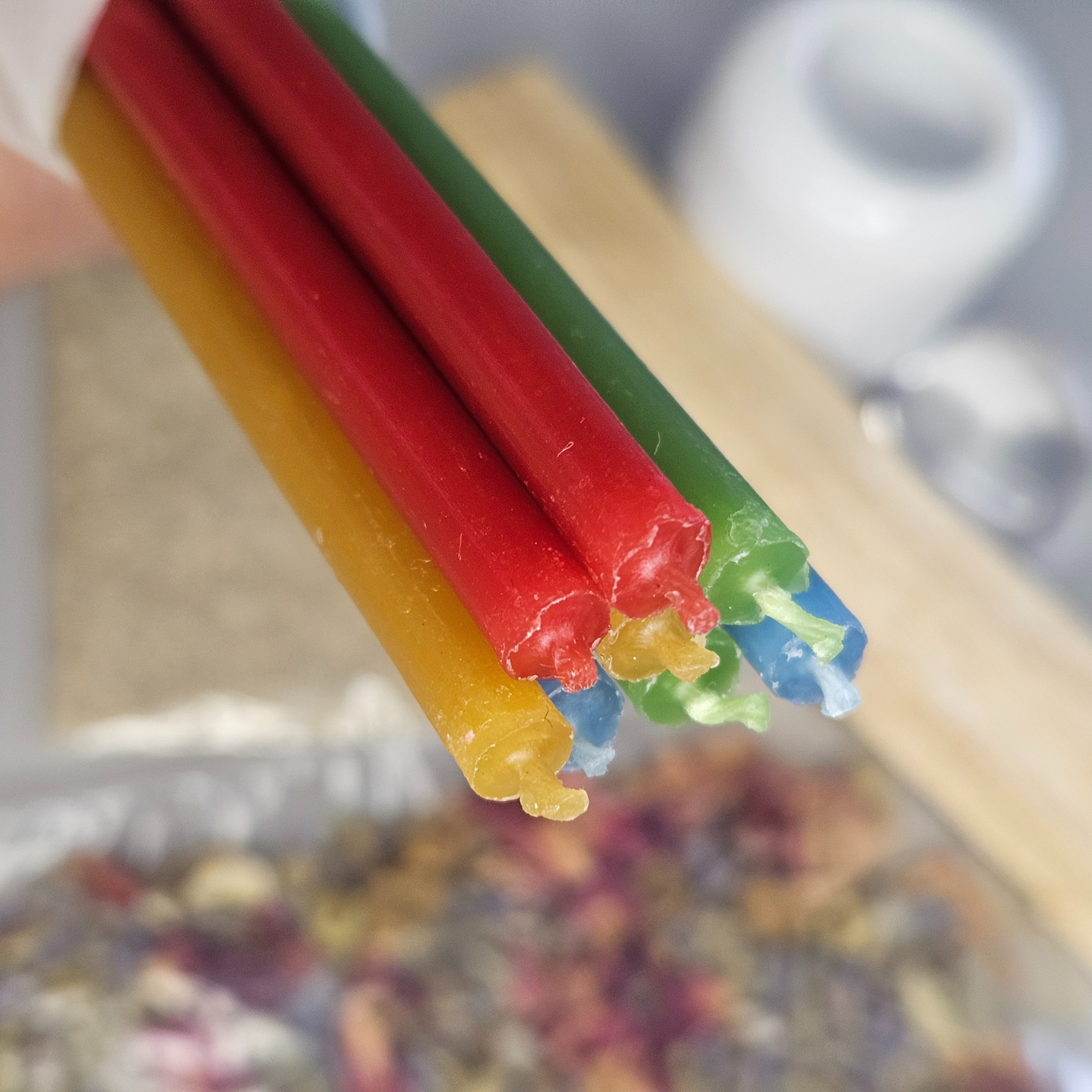 Vier farbige Bienenwachskerzen in Rot, Grün, Blau und Gelb aus dem Essence Ritual Kit – nachhaltige Kerzen für Rituale und Manifestationen.